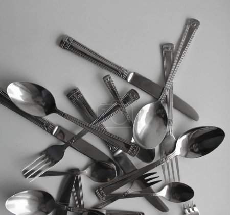 Mix Of Silvery Forks, Knives And Spoons For Eating Closeup View. Photo For Cutlery Concept Backgrounds