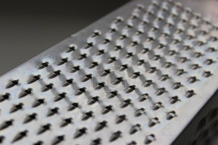 Closeup view of one of the sides of a square kitchen cheese grater