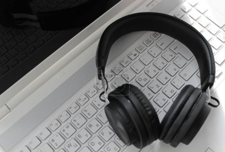 Distrant Work Illustration Stock Image. Black Headphone On Computer Keyboard With Latin And Cyrillic Letters
