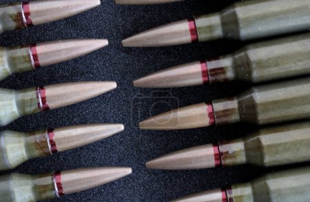 Rifle Bullets In Head To Head Order Closeup View. Stock Photo For Military Backgrounds