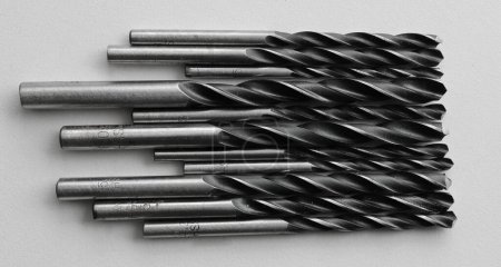 Evenly laid out adjacent drill bits for an electric drill. Stock photo for perforating and drilling illustration