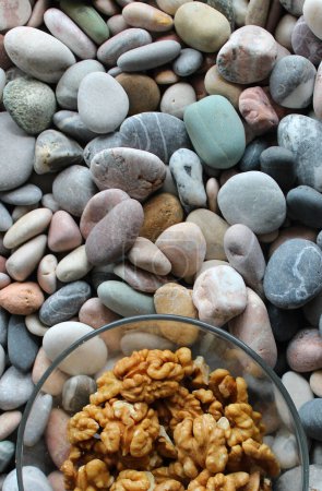 Glass With Walnut Kernels On A Sea Stones Stock Photo For Vertical Story 