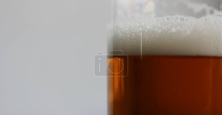 Foam On Brown Strong Beer In A Beer Glass Extreme Closeup Stock Photo