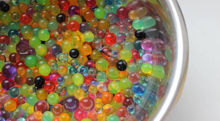 Colorful Gel Balls Inside Metal Bowl On White Surface