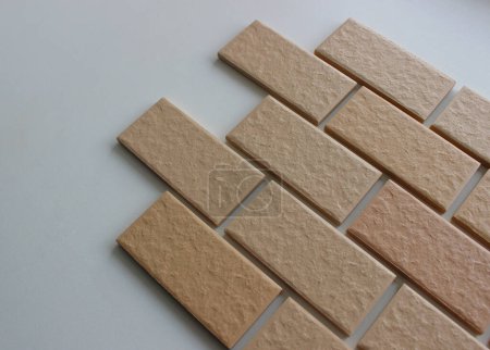 Facing tiles imitating the surface of bricks on a white surface angle view stock photo