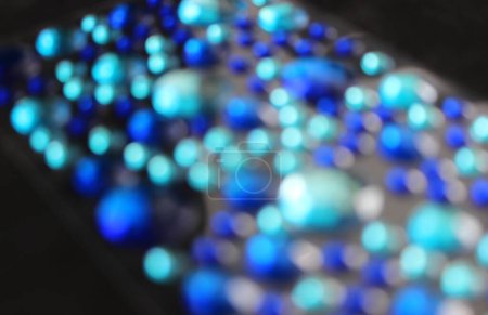 Glares Of Different Size Blue Crystals Sparkles On Black Background Out Of Focus. Stock Photo For Abstract Light Effect Illustration