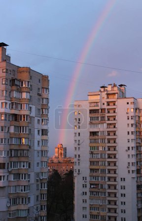 The rainbow seems to come from a residential building between two high-rise buildings