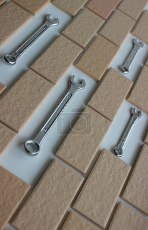 Hex Head Wrenches On Free Spaces In Surface Covered Brick Tiles. Home Repairing Stock Photo For Vertical Story