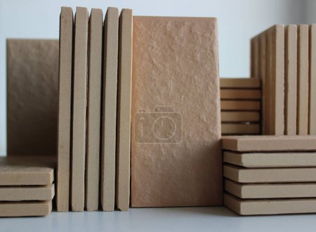 Side view of stacks of same ceramic tiles isolated on white stock photo 