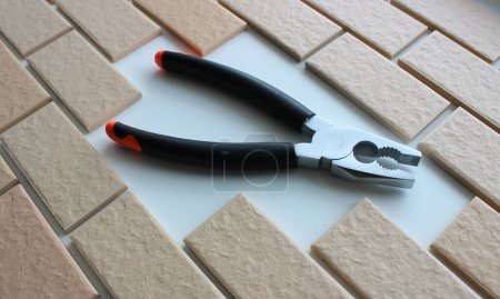Steel Pliers With Black Handles Inside Empty Part Of Brickwork. Stock Image For Home Renovation Illustration