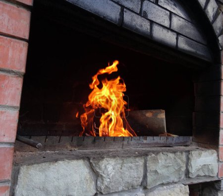 Soot Off Bricks Of Old Wood Oven With Burning Logs   