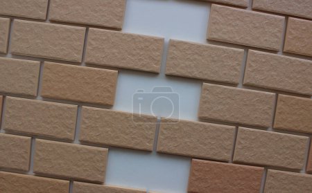 Three same empty niches in even rows of wall tiles with imitation bricks. Stock image for illustration of home renovation 