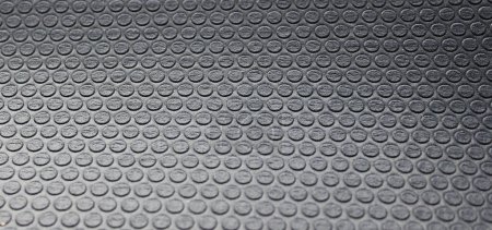 Abstrakte Textur von Reihen kleiner Kreise auf dunkelgrauen stoßfesten Material kostenlose Lizenzgebühren Foto für Paket-und Isoliermaterialien Hintergründe 