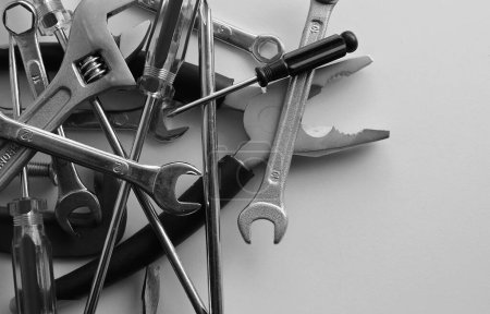 Black And White Tools And Equipment Stock Image. Pliers, Wrenches, Spanners, Screwdrivers, Clamps And Hex Keys Disorderly Scattered Closeup Angle View