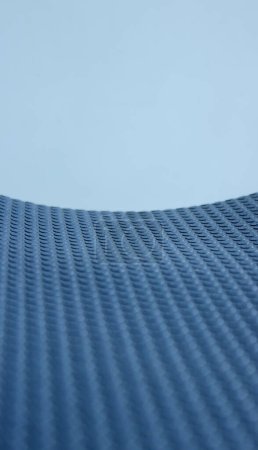 Pattern of rows of small circles on blue elastic insulation material stock photo for vertical abstract surface backgrounds 