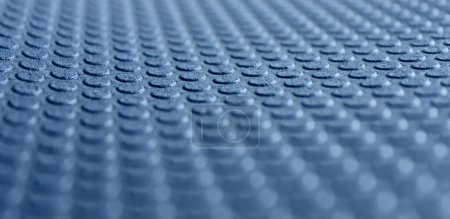Circle embossed pattern on a blue porous material with defocused top and bottom edges. 3d background stock photo