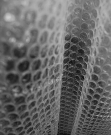 Muster von Rolled Air Bubble Wrap Detaillierte Archivfoto. Textur von Blasenwickelfilm-Quadrat-Bild