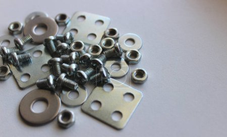 Pile Of Small Hardware On Clean White Surface At A Side Of Image. Stock Photo For Hardware Items Backgrounds