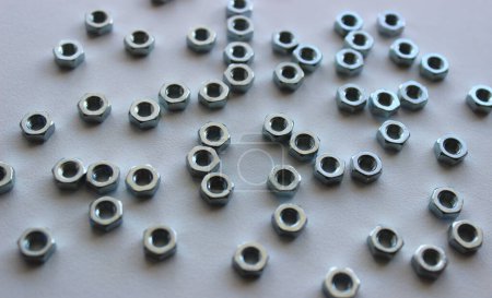 Shiny Metal Hex Nuts Scattered On White Plastic Sheet Detailed Stock Photo