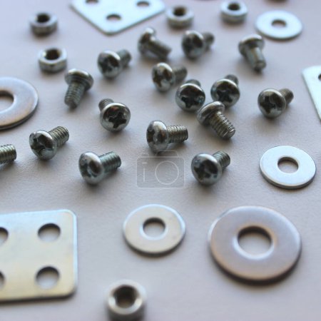 Variety Metal Steel Fastener And Fixing Items Scattered On Scratched Surface Macro Shot Stock Photo. Ironware Goods Royalty Free Background