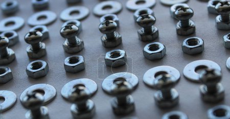 Photo for Extreme Closeup Photo Of Rows Made With Shiny Bolts, Washers And Nuts - Royalty Free Image