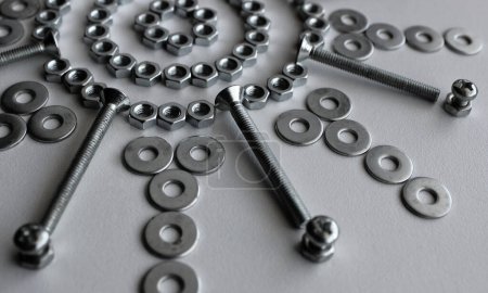 Part Of Design Pattern Of Steel Fasteners And Bolts In Star Shape On White Surface 