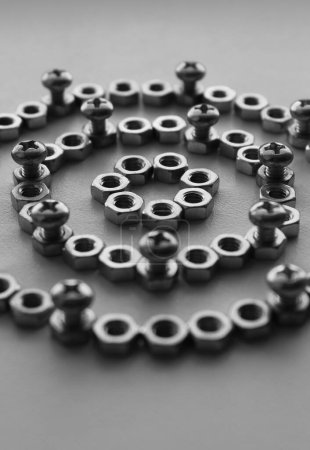Black and white image of thread bolts injected in fixing nuts between flat washers. Macro shot stock photo for hardware products illustration 
