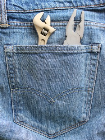 Sturdy Double Stitched Pocket To Hold Heavy Tools. Pliers And Adjustable Spanner Inside Denim Fabric Pocket Stock Photo For Vertical Story