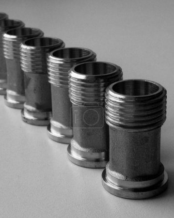 Threaded Plumbing Fitting Made With Cast Iron Arranged In Row Isolated Stock Photo