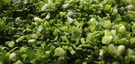 Couche de légumes verts fraîchement hachés et oignon vue en angle rapproché 