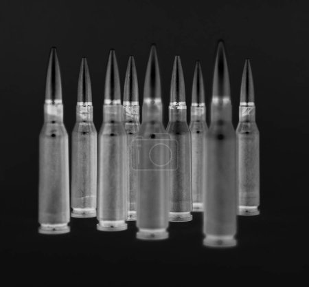 Group of bullets stay on a black background in radiograph style creative stock image