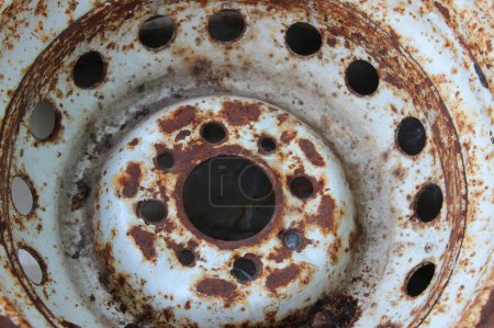 Old iron wheel rim with areas affected by corrosion. Old car parts recycling stock photo