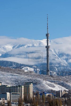 The famous TV tower in Almaty (Kazakhstan), located at an altitude of more than 1400 meters above sea level against the backdrop of snowy mountains