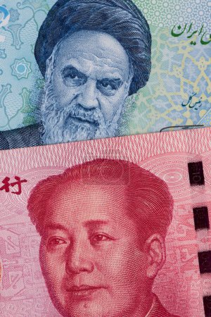 Photo for Fragments of banknotes of 100 Chinese yuan and 2/2000 Iranian tuman/reals with portraits of Chairman Moa and Ruhollah Khomeini - Royalty Free Image