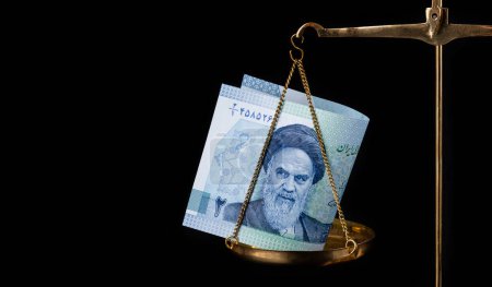 Photo for Fragments of banknote 2-2000 Iranian tuman-reals with portrait of  Ruhollah Khomeini on the scales - Royalty Free Image