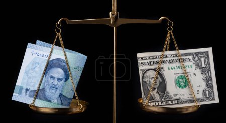 Photo for American and Iranian banknotes on a bowl of golden scales on a black background - Royalty Free Image