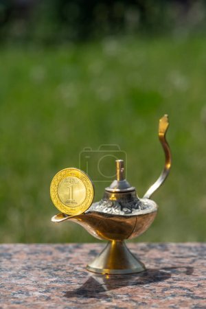 Photo for Aladdin's magic lamp and 1 riyal coin of the Kingdom of Saudi Arabia - Royalty Free Image