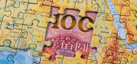 Photo for A puzzle map of African countries and a fragment of a 100 Chinese yuan bill - Royalty Free Image