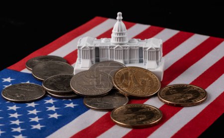 Foto de Modelo en miniatura del edificio del Capitolio en Washington, DC, bandera estadounidense y monedas de 1 y 25 centavos de dólar - Imagen libre de derechos