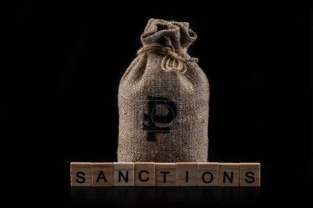 Money bag with Russian ruble symbol and the word "sanctions" on a black background