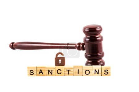 Judge's gavel, symbolic padlock with keyhole and the word "sanctions" on a white background