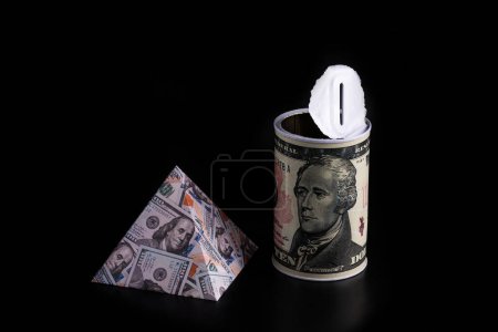 Pyramid with a picture of 100 US dollar bills and an empty piggy bank with a picture of a 10 US dollar bill
