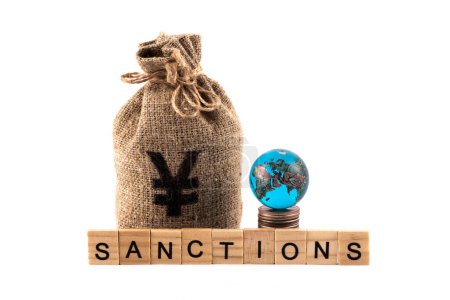 Glass globe, money bag with Chinese Yuan symbol and the word "sanctions" on a white background