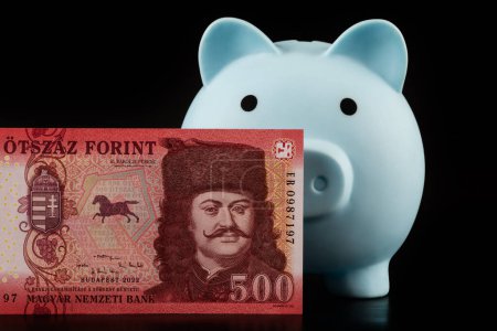500 Hungarian forint banknote and piggy bank on black background