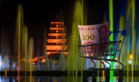 100 yuan bill in a shopping cart against the background of an ancient Chinese pagoda