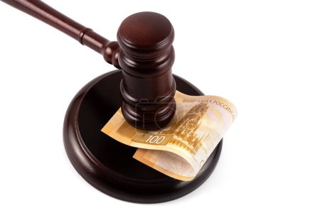 Judge's gavel and 100 Russian ruble banknote on a white background