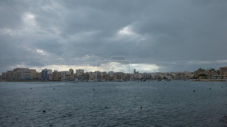 Photo for Cityscape ob Birzebbuga on malta on a cloudy autumn day with rain coming in. - Royalty Free Image