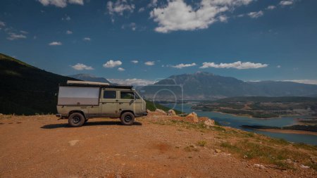 Photo for Adventure oldtimer van or camper, campervan on high plain with good view panorama of city Kukes in albania on a summer day. Albanian roadtrip with vintage campervan - Royalty Free Image