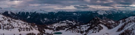 Téléchargez les photos : Aerial drone panorama of Zoncolan ski resort in northern Italy on a cloudy winter day. Visible mountains around, good visibility. - en image libre de droit