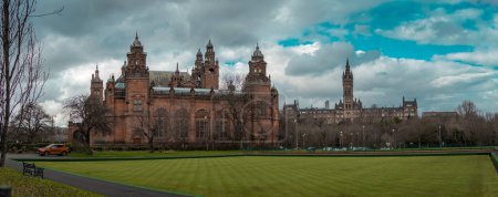 Photo for Wide panorama of Kelvingrove art gallery in Glasgow on a cloudy spring day. Beautiful green grass in front of it. - Royalty Free Image